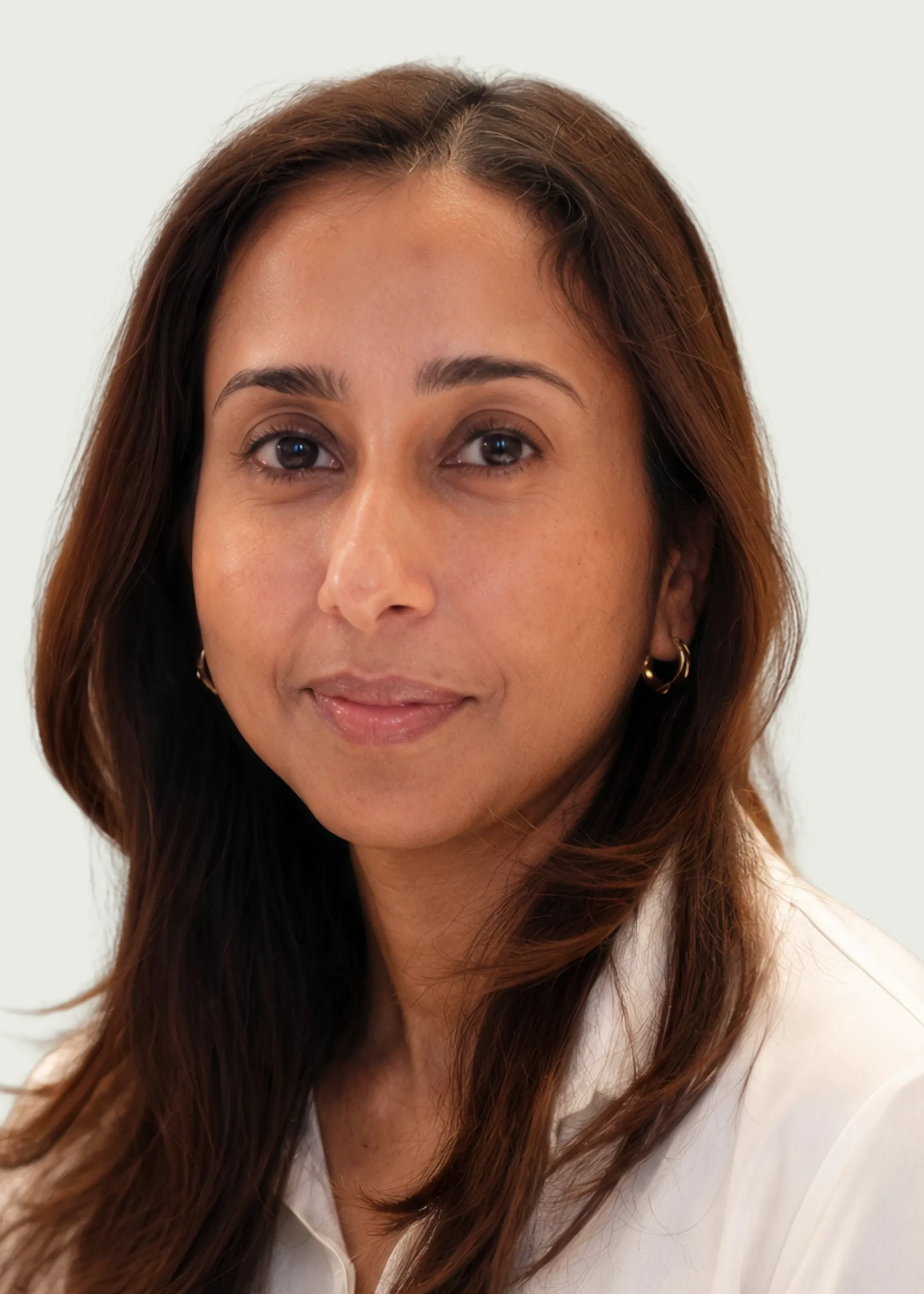 Professional headshot of female doctor smiling in white coat.