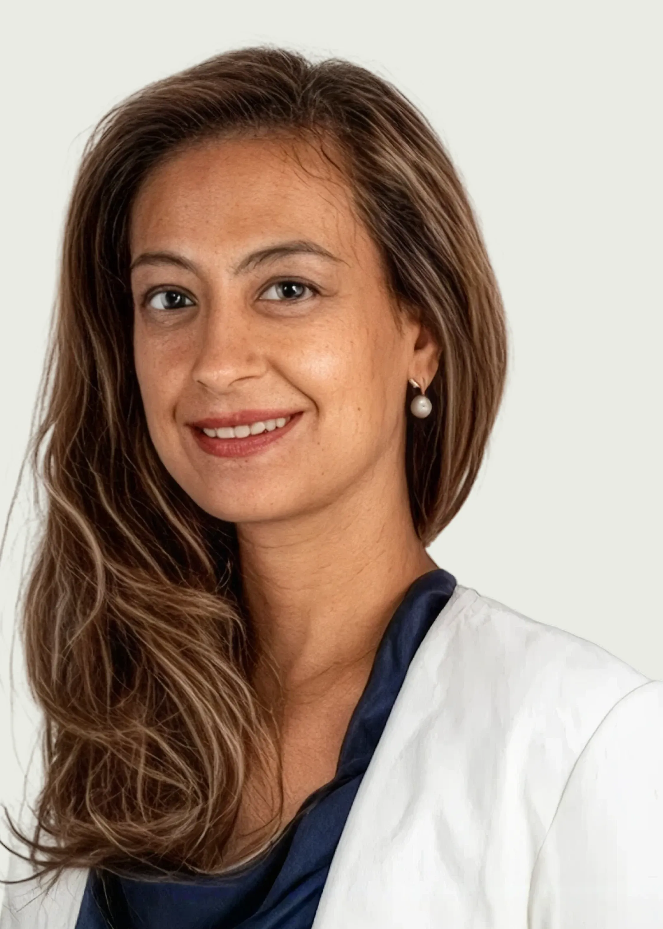 Professional headshot of female doctor smiling in white coat.