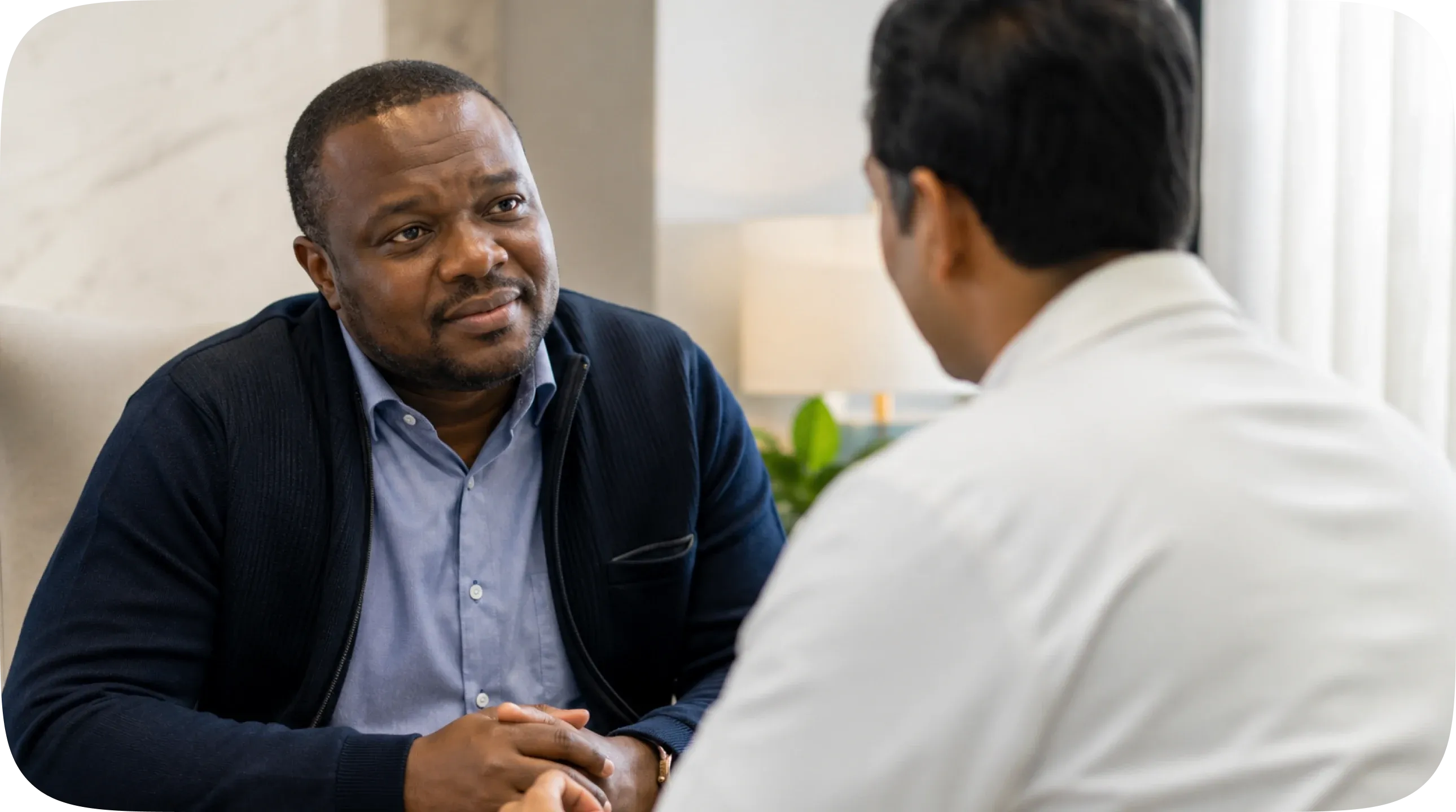 man discussing treatment with doctor